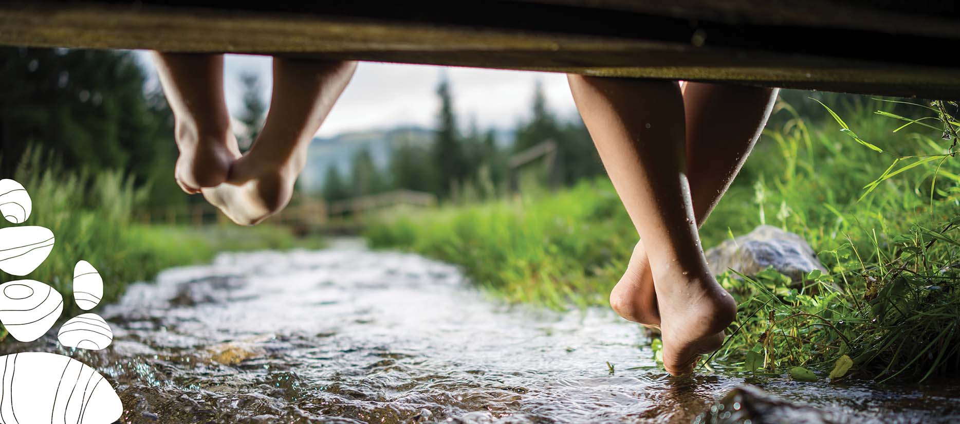 legs dangling over small creek near duffins creek ajax